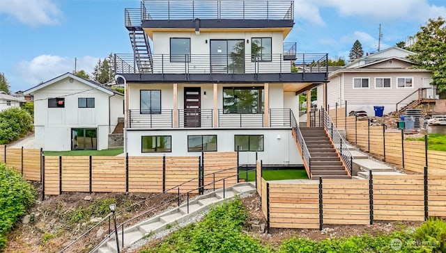 7253 S Taft St, Seattle, WA 98178 - back of house featuring stairs, a balcony, a fenced backyard, and stucco siding