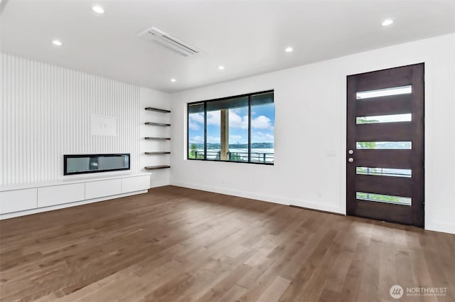 7253 S Taft St, Seattle, WA 98178 - unfurnished living room with wood finished floors, recessed lighting, built in features, and baseboards