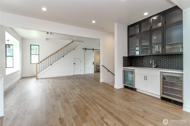 7253 S Taft St, Seattle, WA 98178 - indoor wet bar with wine cooler, a barn door, light wood-type flooring, and recessed lighting