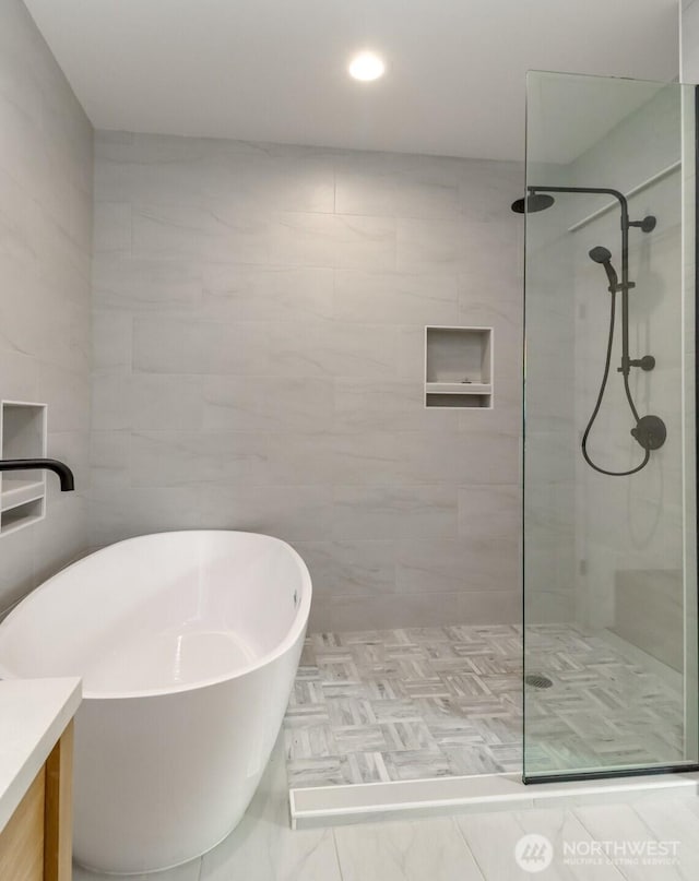 7253 S Taft St, Seattle, WA 98178 - bathroom with vanity, walk in shower, a freestanding tub, and tile walls