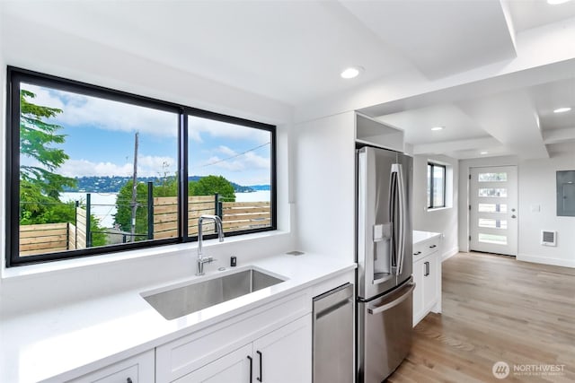 7253 S Taft St, Seattle, WA 98178 - kitchen featuring stainless steel appliances, a sink, light wood-style flooring, white cabinetry, and recessed lighting