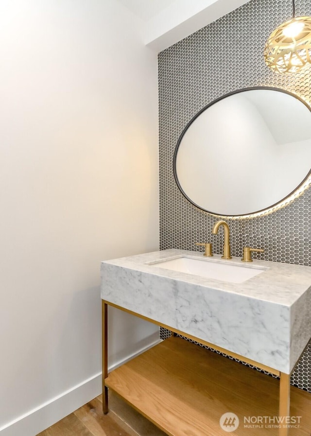 7253 S Taft St, Seattle, WA 98178 - bathroom with wood finished floors, decorative backsplash, baseboards, and vanity