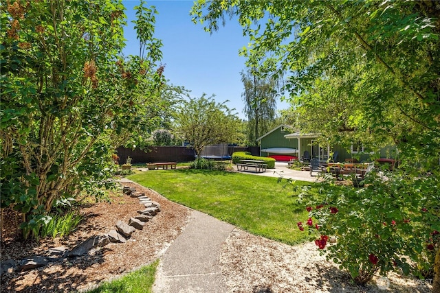 4404 29th Ave SE, Lacey, WA 98503 - fenced backyard with a trampoline and a patio area