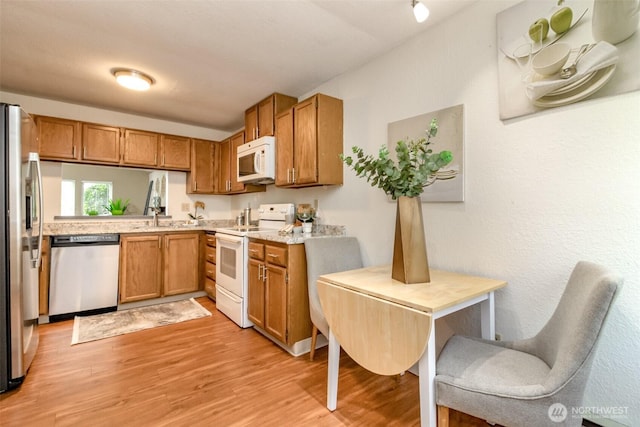 13714 SE 258th Pl Unit 36, Kent, WA 98042 - kitchen with stainless steel appliances, light countertops, and brown cabinetry