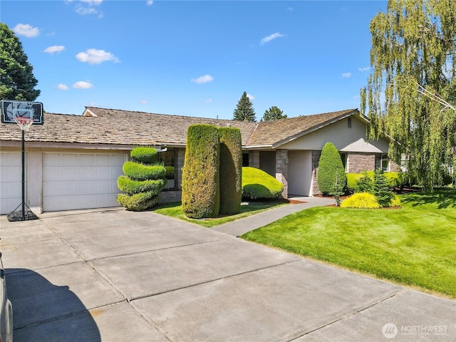 1525 E Catalpa St, Othello, WA 99344 - ranch-style house featuring concrete driveway, a front lawn, a garage, and stucco siding