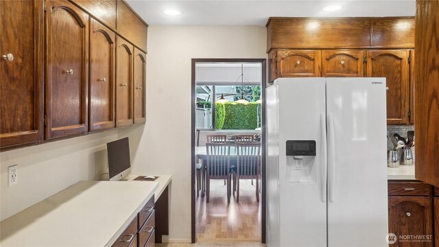 1525 E Catalpa St, Othello, WA 99344 - kitchen featuring white refrigerator with ice dispenser, light countertops, recessed lighting, a desk, and brown cabinets