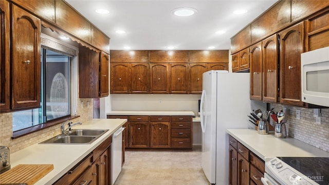 1525 E Catalpa St, Othello, WA 99344 - kitchen with a sink, dishwasher, white microwave, tasteful backsplash, and light countertops