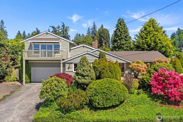 22035 99th Pl W, Edmonds, WA 98020 - view of front facade featuring a garage, concrete driveway, a chimney, and a balcony