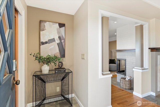 22035 99th Pl W, Edmonds, WA 98020 - entryway featuring a brick fireplace, baseboards, and wood finished floors