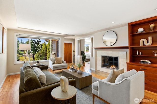 22035 99th Pl W, Edmonds, WA 98020 - living room with light wood-style flooring, a fireplace, and baseboards