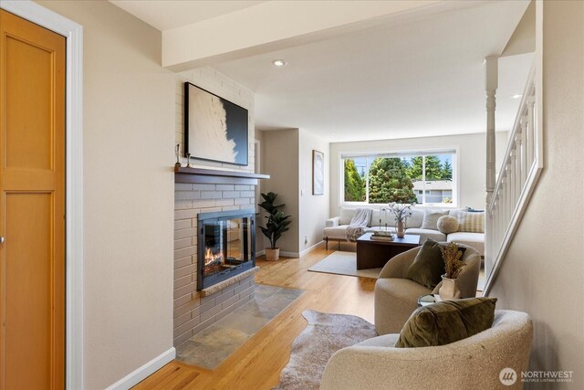 22035 99th Pl W, Edmonds, WA 98020 - living room featuring baseboards, light wood finished floors, a fireplace, recessed lighting, and stairway