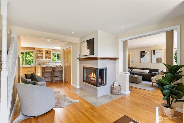 22035 99th Pl W, Edmonds, WA 98020 - living area featuring a multi sided fireplace, light wood-type flooring, recessed lighting, and baseboards