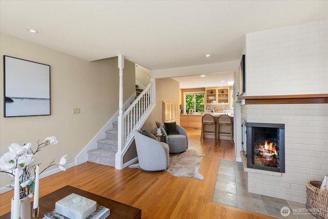 22035 99th Pl W, Edmonds, WA 98020 - living area with stairway, light wood-style flooring, a fireplace, baseboards, and recessed lighting