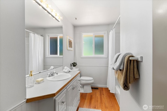 22035 99th Pl W, Edmonds, WA 98020 - full bathroom with wainscoting, wood finished floors, vanity, toilet, and a shower with shower curtain