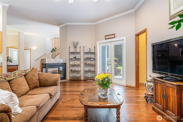 6841 NW Ranger Way, Silverdale, WA 98383 - living room featuring crown molding, wood finished floors, baseboards, and a multi sided fireplace
