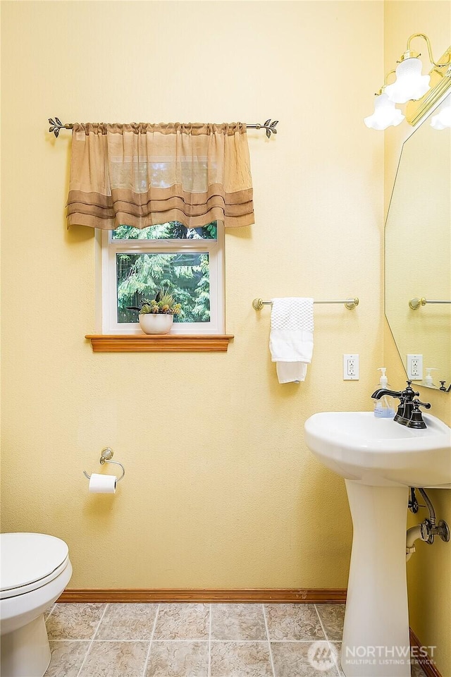 6841 NW Ranger Way, Silverdale, WA 98383 - bathroom featuring baseboards, toilet, and a sink
