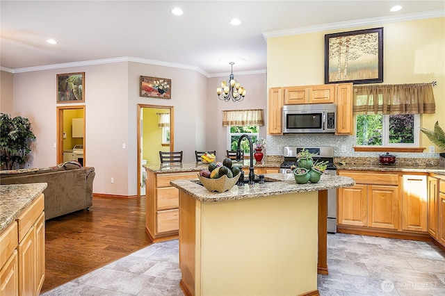 6841 NW Ranger Way, Silverdale, WA 98383 - kitchen featuring stainless steel appliances, a kitchen island with sink, ornamental molding, a chandelier, and decorative backsplash