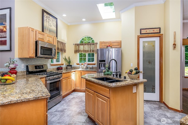 6841 NW Ranger Way, Silverdale, WA 98383 - kitchen featuring appliances with stainless steel finishes, a sink, ornamental molding, an island with sink, and a skylight