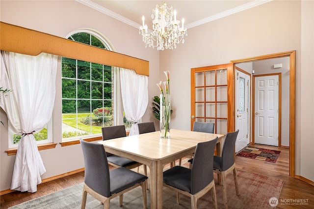 6841 NW Ranger Way, Silverdale, WA 98383 - dining area with ornamental molding, a chandelier, baseboards, and wood finished floors