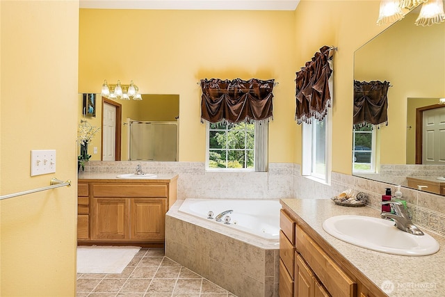 6841 NW Ranger Way, Silverdale, WA 98383 - full bathroom featuring a whirlpool tub, two vanities, a stall shower, and tile patterned floors