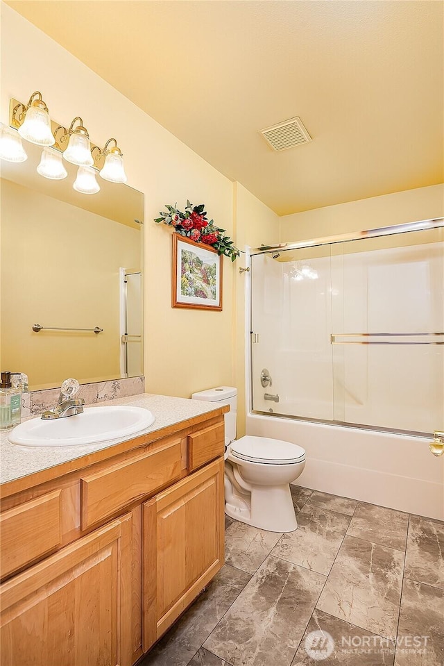 6841 NW Ranger Way, Silverdale, WA 98383 - full bathroom featuring vanity, toilet, and bath / shower combo with glass door