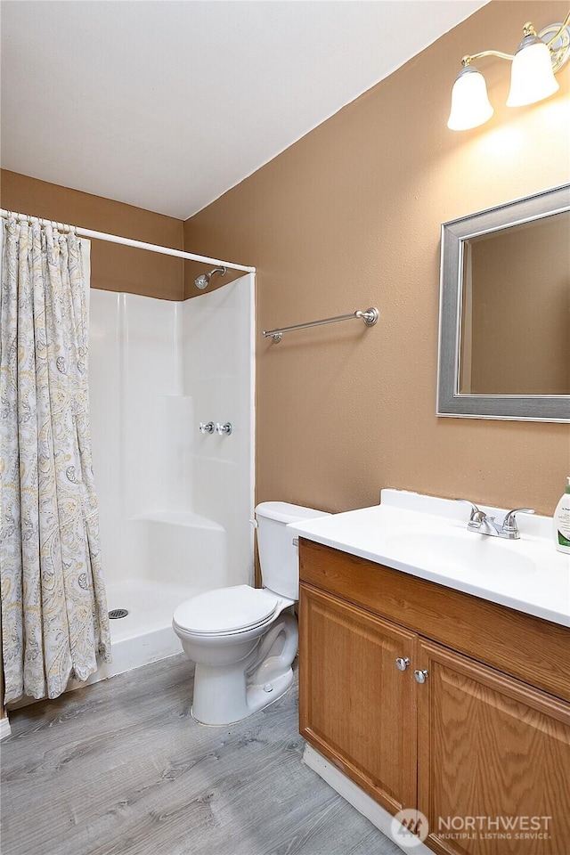6841 NW Ranger Way, Silverdale, WA 98383 - full bath with wood finished floors, vanity, toilet, and a shower with shower curtain