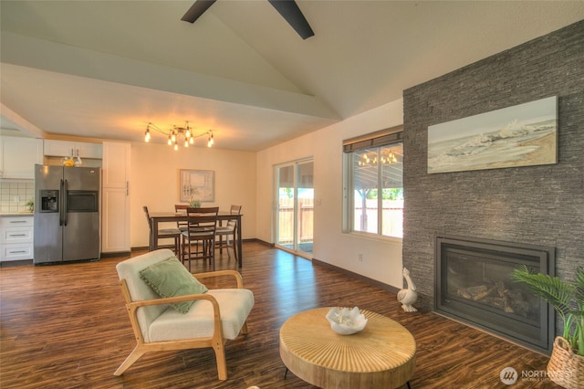 872 Albion Ave SE, Ocean Shores, WA 98569 - living area with dark wood-type flooring, a stone fireplace, a chandelier, high vaulted ceiling, and ceiling fan
