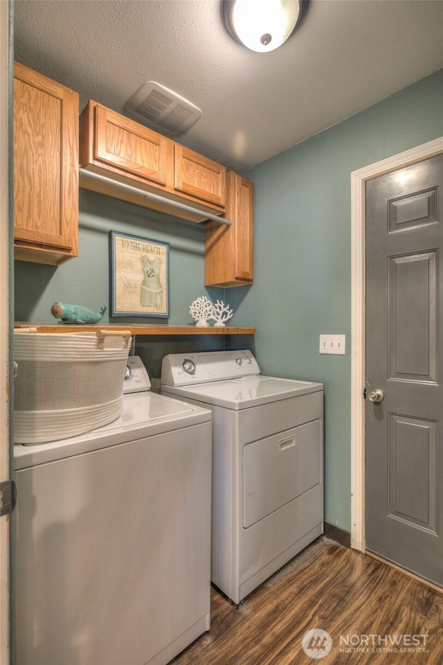 872 Albion Ave SE, Ocean Shores, WA 98569 - laundry area with cabinet space, washer and dryer, and dark wood-type flooring