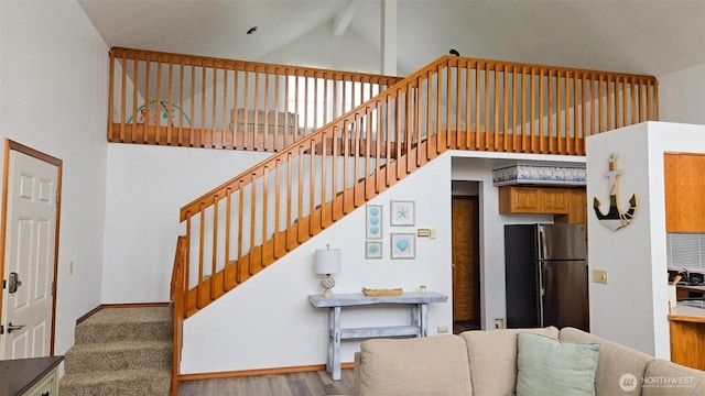 1249 E Ocean Shores Blvd SW, Ocean Shores, WA 98569 - stairs with high vaulted ceiling, beam ceiling, and wood finished floors