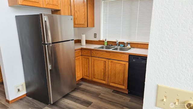 1249 E Ocean Shores Blvd SW, Ocean Shores, WA 98569 - kitchen featuring freestanding refrigerator, light countertops, dark wood-style flooring, and brown cabinets