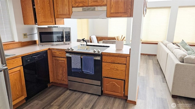 1249 E Ocean Shores Blvd SW, Ocean Shores, WA 98569 - kitchen featuring stainless steel appliances, dark wood-style flooring, light countertops, open floor plan, and premium range hood