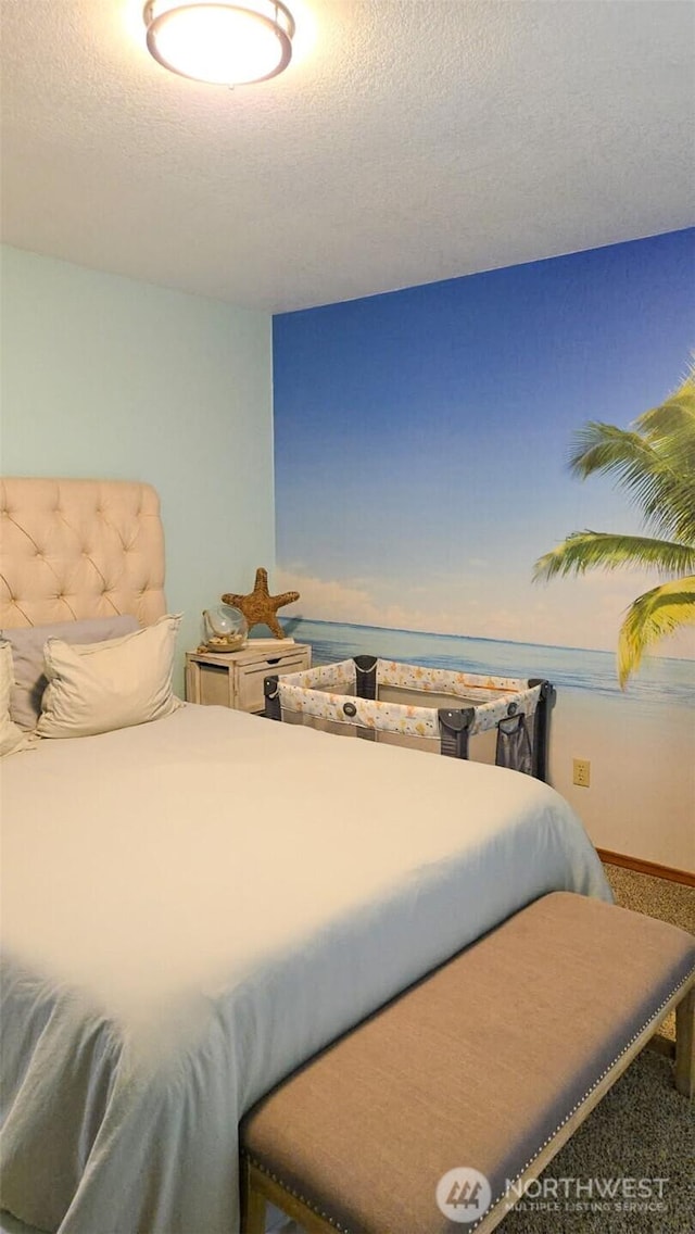 1249 E Ocean Shores Blvd SW, Ocean Shores, WA 98569 - bedroom featuring carpet floors, a water view, and a textured ceiling