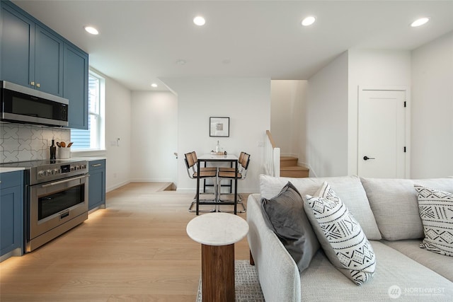 3639 34th Ave W Unit B, Seattle, WA 98199 - living area featuring light wood-type flooring, recessed lighting, stairs, and baseboards