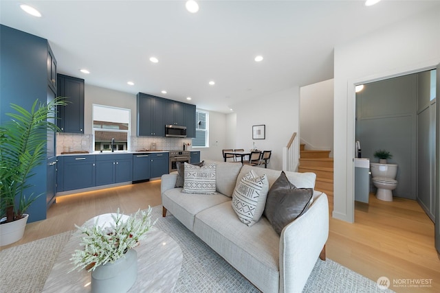 3639 34th Ave W Unit B, Seattle, WA 98199 - living area featuring light wood-style floors, stairway, and recessed lighting