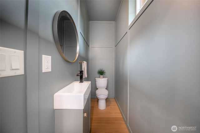 3639 34th Ave W Unit B, Seattle, WA 98199 - bathroom with toilet, vanity, and wood finished floors