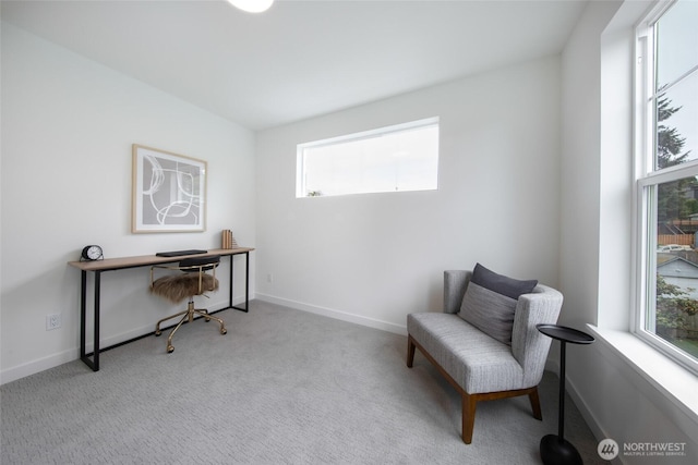 3639 34th Ave W Unit B, Seattle, WA 98199 - living area with healthy amount of natural light, carpet flooring, baseboards, and a desk