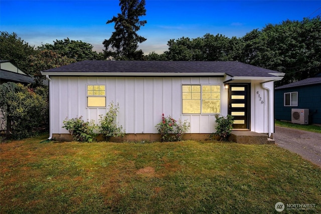4126 19th Ave SW, Seattle, WA 98106 - view of front of house featuring board and batten siding, ac unit, a front yard, and roof with shingles