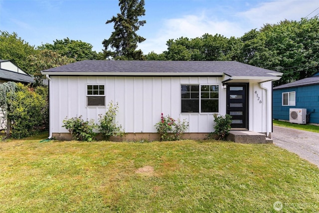 4126 19th Ave SW, Seattle, WA 98106 - view of front of house with board and batten siding, a cooling unit, and a front lawn