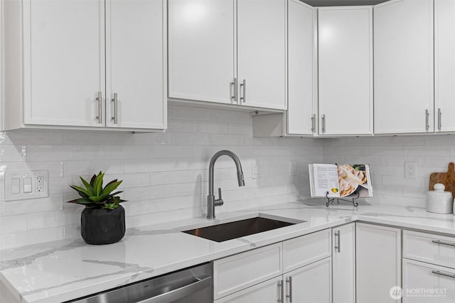 4126 19th Ave SW, Seattle, WA 98106 - kitchen featuring a sink, white cabinetry, and decorative backsplash