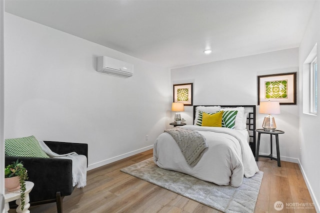 4126 19th Ave SW, Seattle, WA 98106 - bedroom with an AC wall unit, wood finished floors, and baseboards