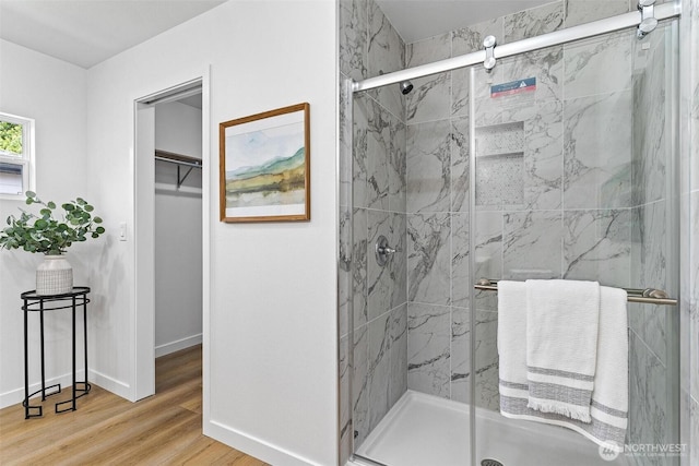 4126 19th Ave SW, Seattle, WA 98106 - bathroom with a marble finish shower, baseboards, wood finished floors, and a spacious closet