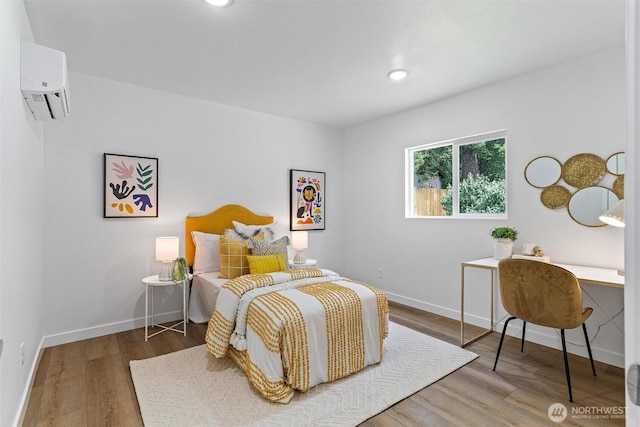 4126 19th Ave SW, Seattle, WA 98106 - bedroom with a wall unit AC, wood finished floors, a desk, baseboards, and recessed lighting