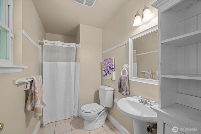 10507 48th St E, Edgewood, WA 98372 - full bath with tile patterned floors, baseboards, toilet, curtained shower, and a sink
