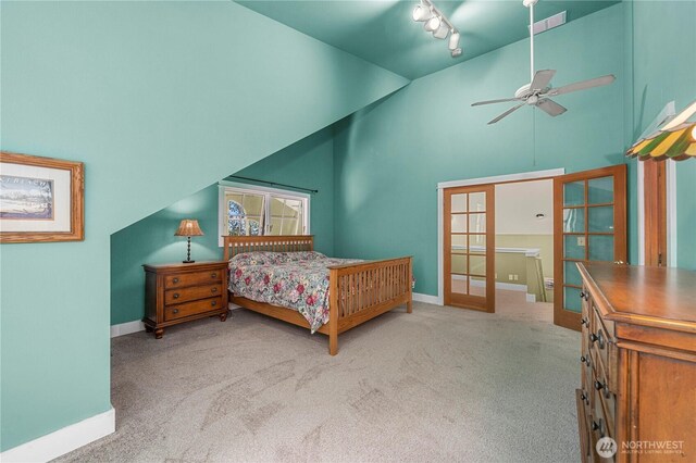 10507 48th St E, Edgewood, WA 98372 - carpeted bedroom with french doors, a towering ceiling, baseboards, and rail lighting