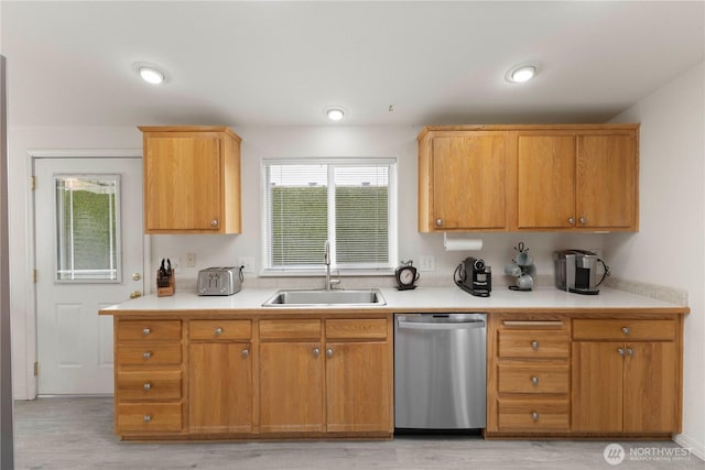 6124 91st St E, Puyallup, WA 98371 - kitchen with dishwasher, a sink, light wood-type flooring, and light countertops