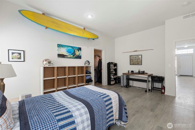 6124 91st St E, Puyallup, WA 98371 - bedroom featuring wood finished floors, a walk in closet, and a closet