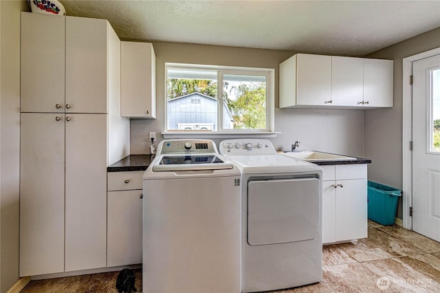 361 E Anderson Rd, Sequim, WA 98382 - washroom featuring cabinet space, washer and dryer, healthy amount of natural light, and a textured ceiling