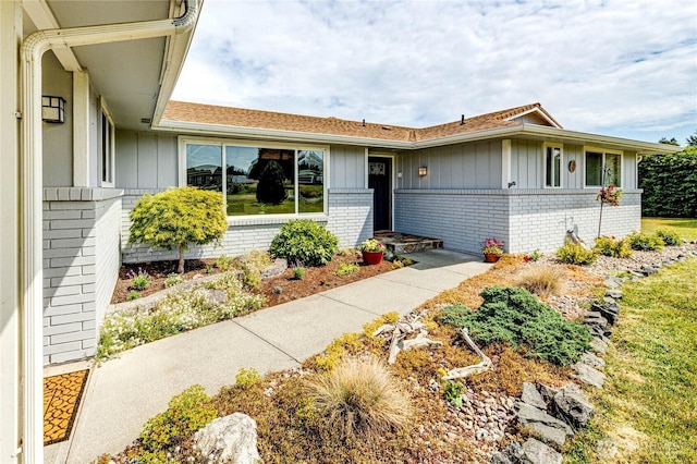 361 E Anderson Rd, Sequim, WA 98382 - view of front of property with board and batten siding, brick siding, and a shingled roof