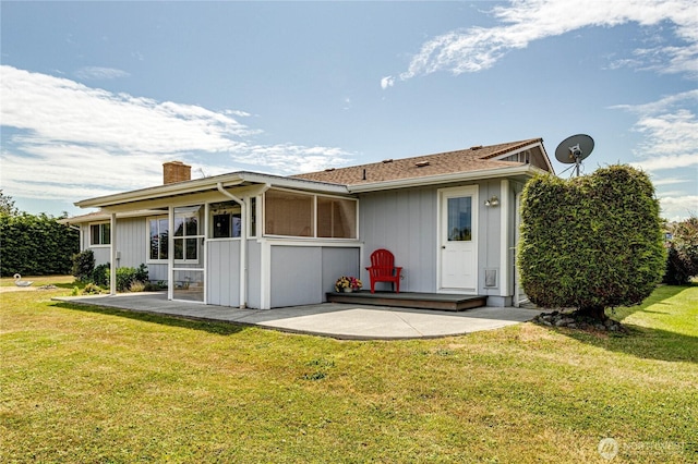 361 E Anderson Rd, Sequim, WA 98382 - back of house with a patio area, a chimney, a lawn, and a sunroom