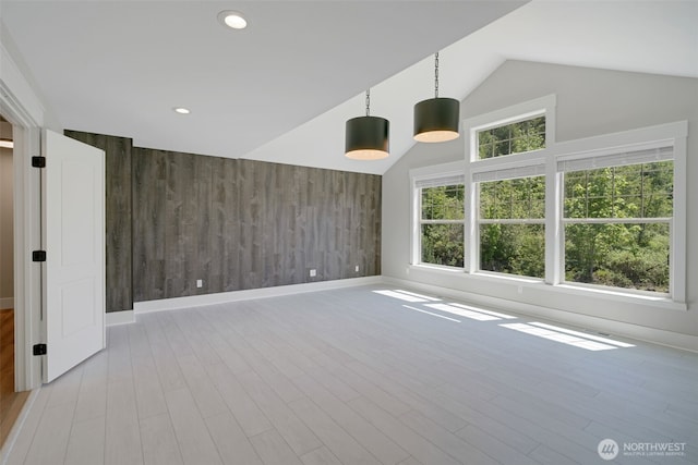5020 Gold Ridge Ln SW, Olympia, WA 98512 - empty room with an accent wall, wooden walls, baseboards, light wood-style floors, and recessed lighting